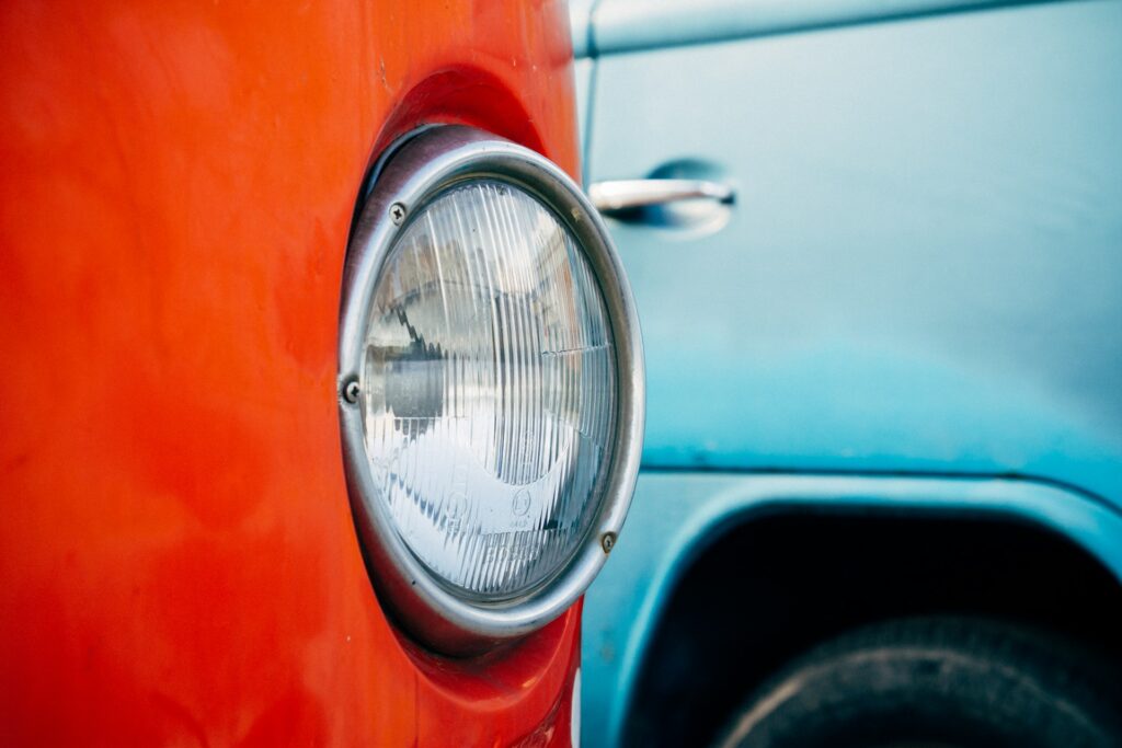 Voiture rouge à côté d'une voiture bleue.